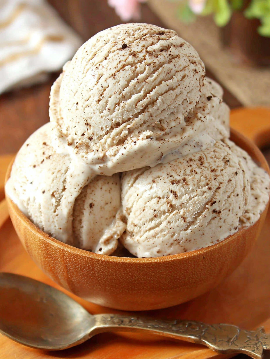 A bowl of ice cream with chocolate chips.