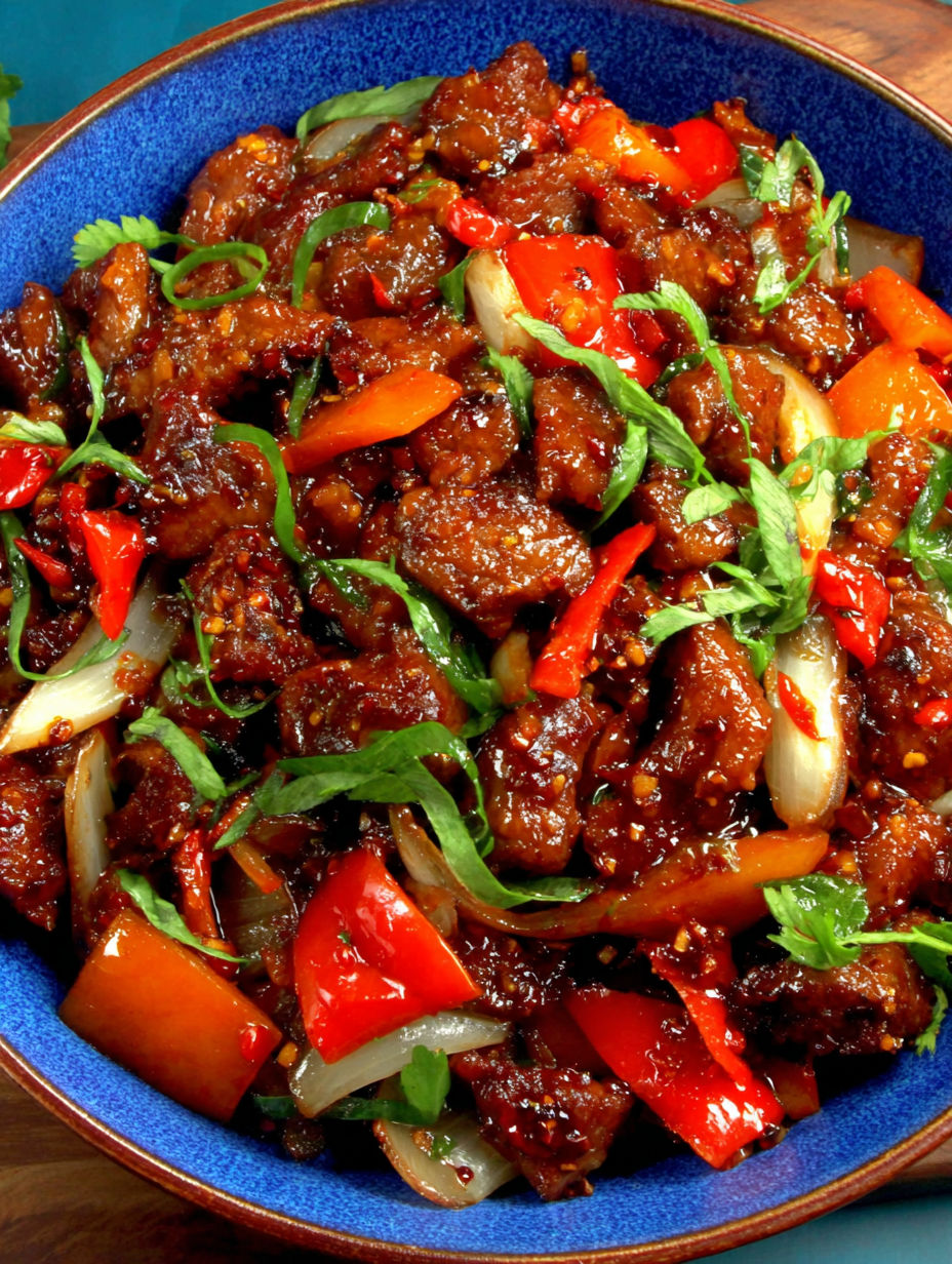 A bowl filled with beef and veggies.