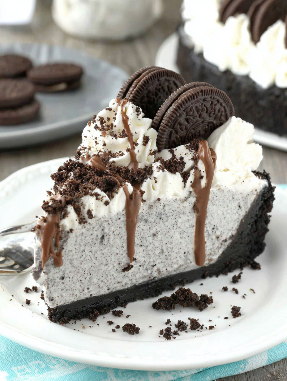 A slice of Oreo cheesecake drizzled with chocolate.