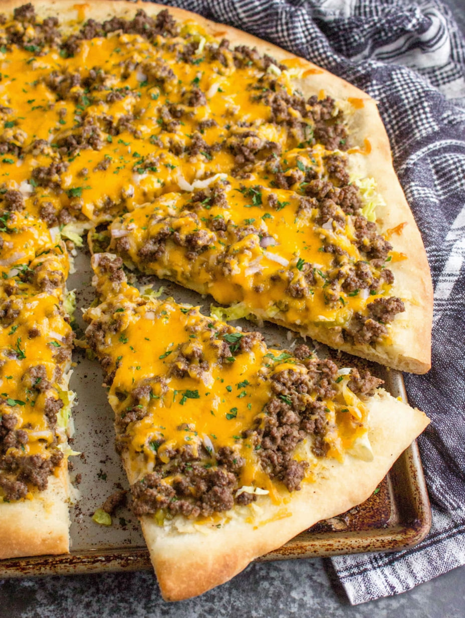 A slice of pizza with cheese and meat on it.