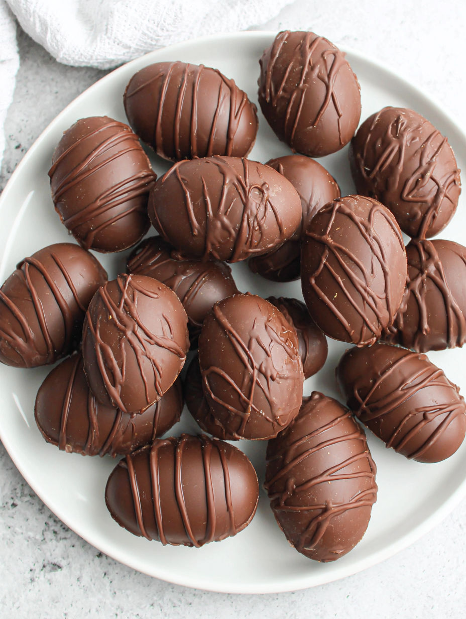 A plate of chocolate covered eggs.