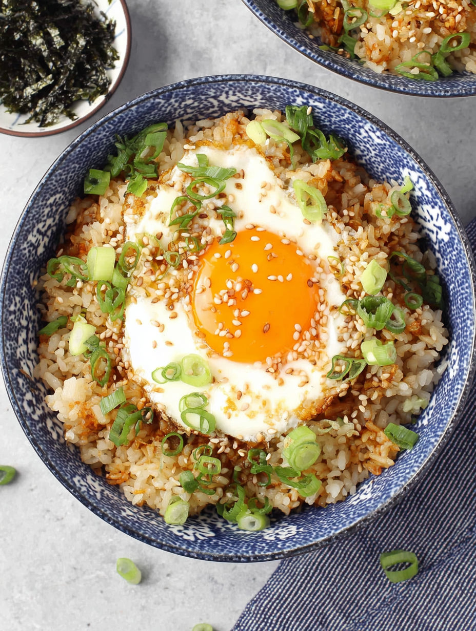 A bowl of rice with an egg in the center.