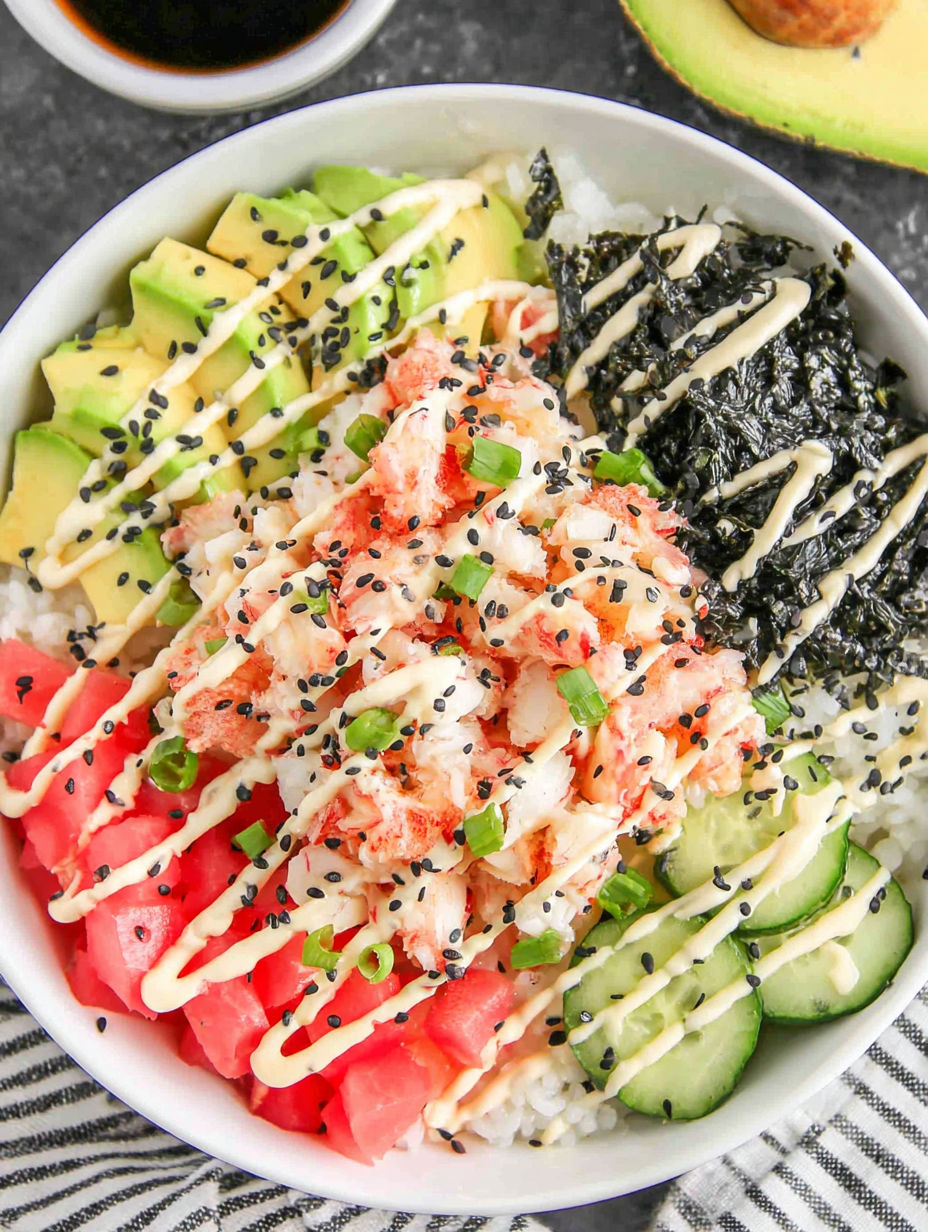 A bowl of sushi featuring rice, avocado, and cucumber.