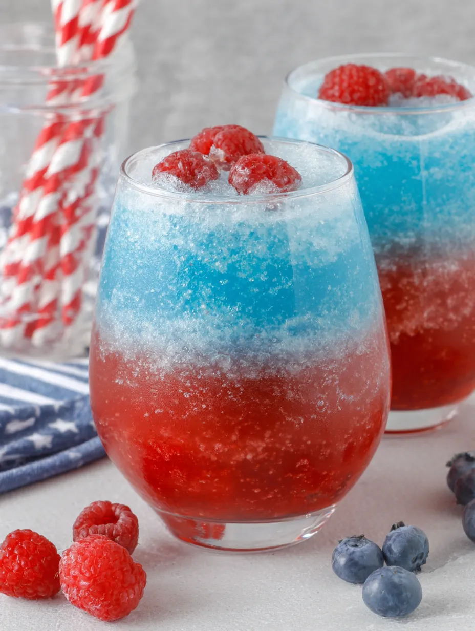 Two glasses of red, white and blue drinks.