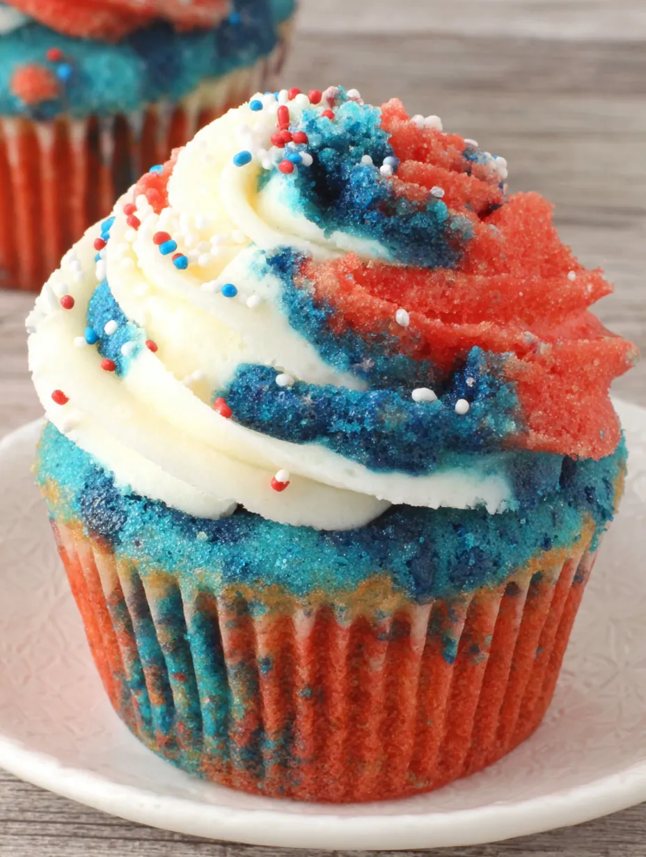 A cupcake with red, white and blue frosting.