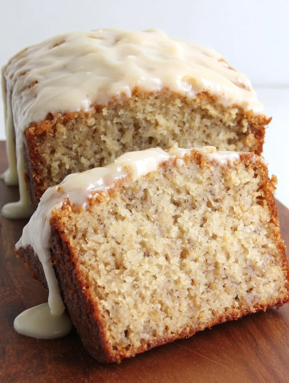A slice of banana cake with cream cheese frosting.
