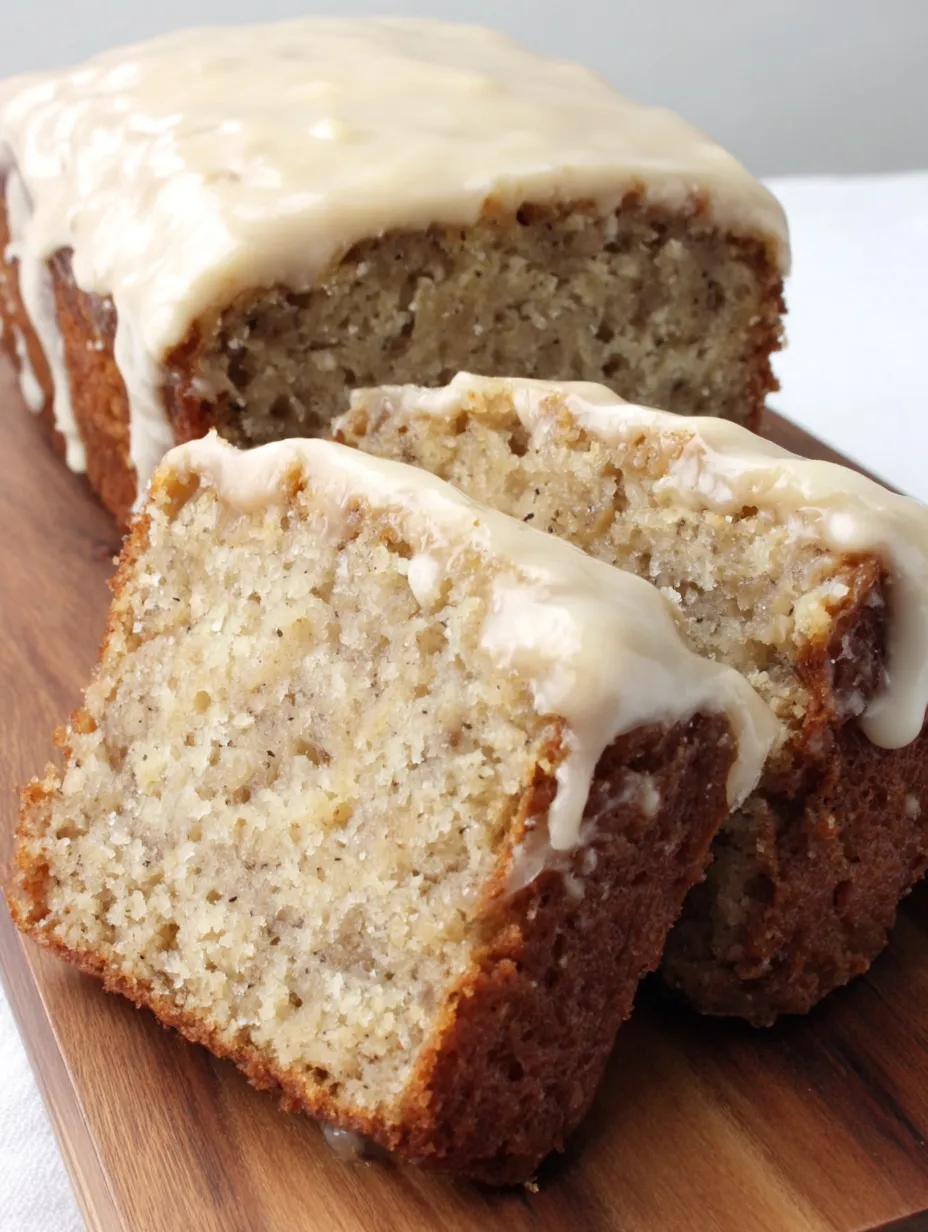 A slice of banana cake with cream cheese frosting.