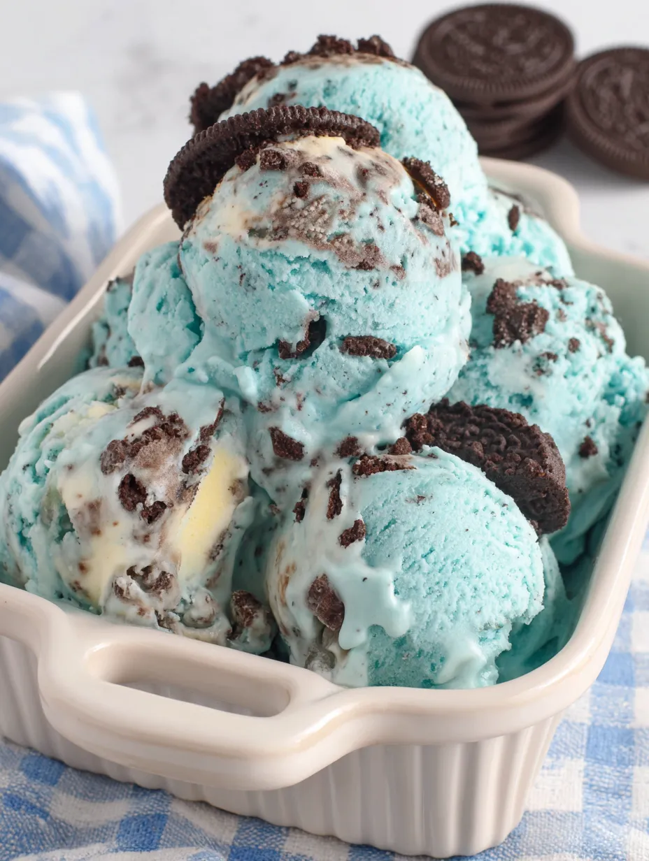 A bowl of ice cream with chocolate chips and cookie crumbles.