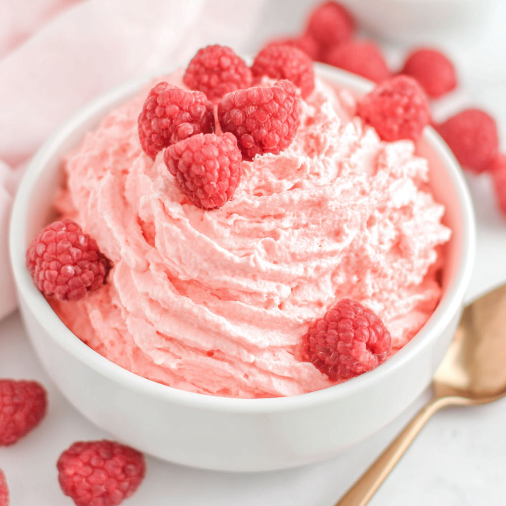 A bowl of pink raspberry jello fluff.