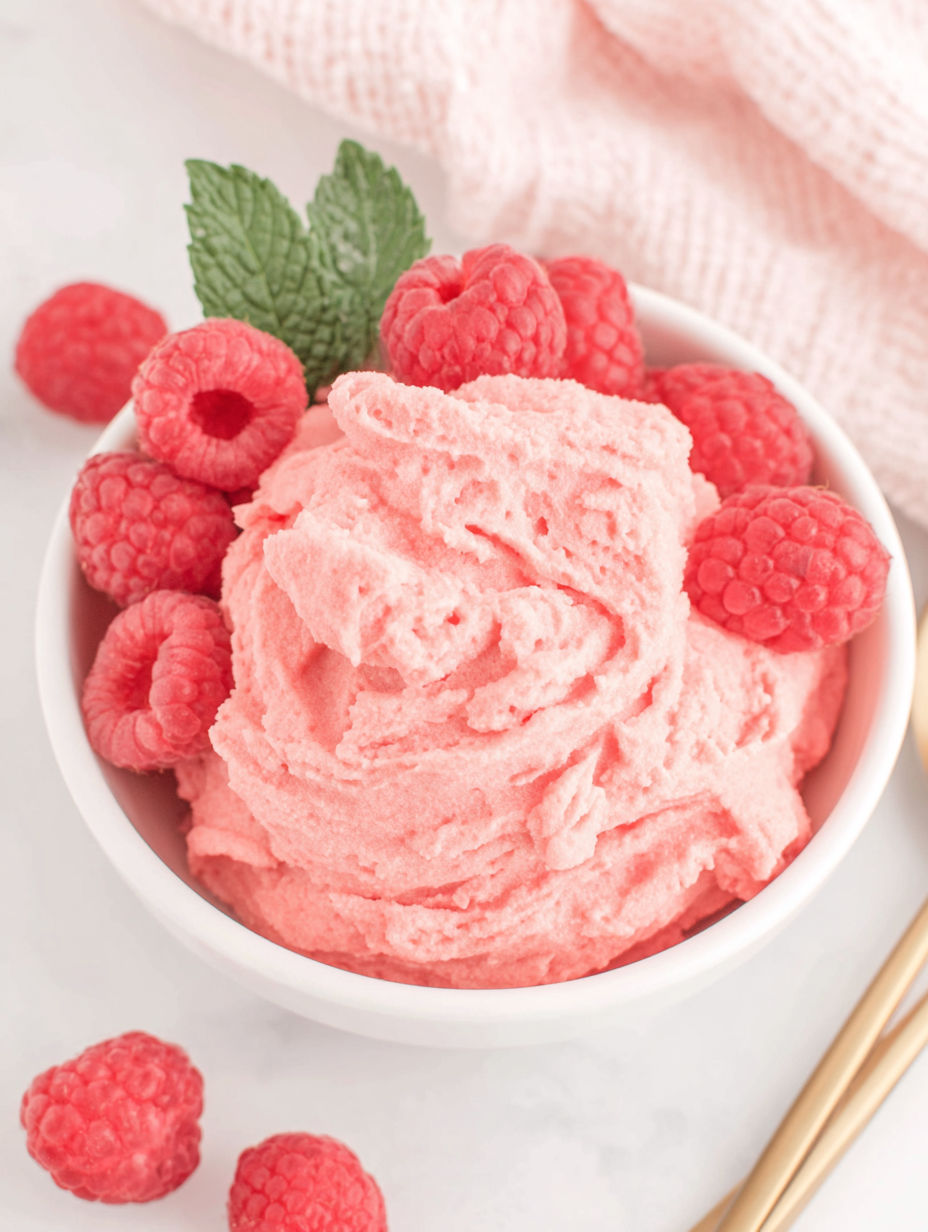 A bowl of pink raspberry sorbet.