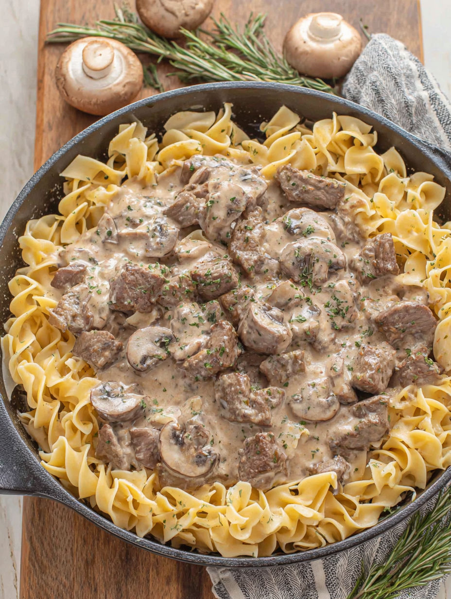 A pan of food with noodles and meat.