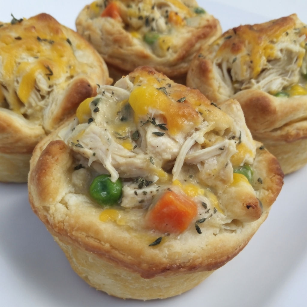 A muffin tin filled with chicken pot pie.