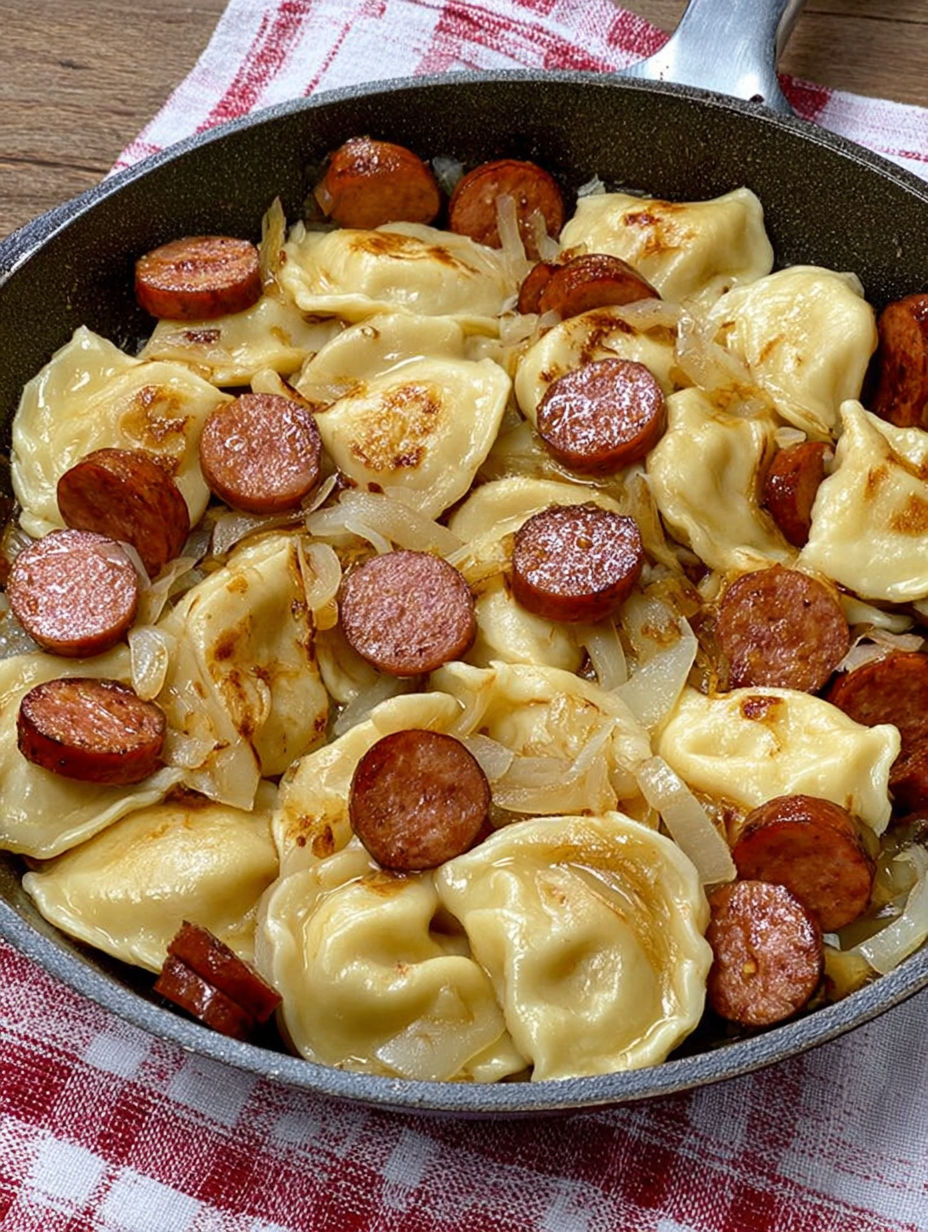 A bowl of food with sausage and onions.