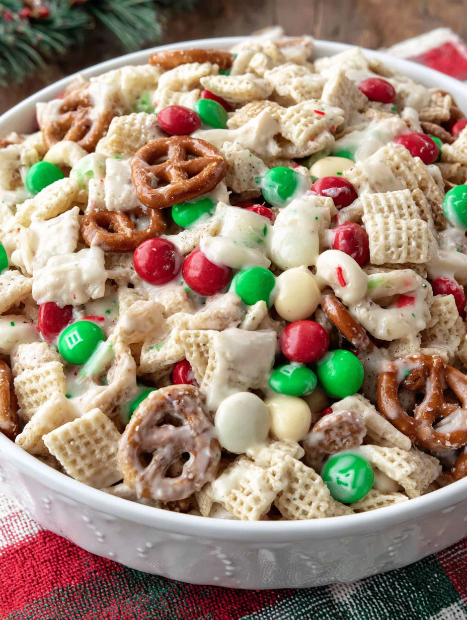A bowl of food with a green and red candy.