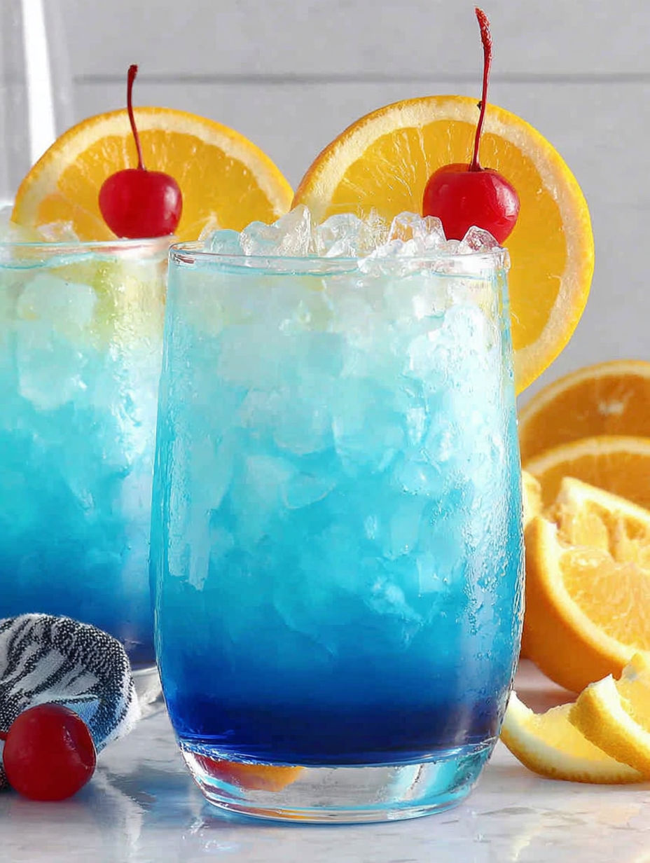 Two blue drinks with orange slices.