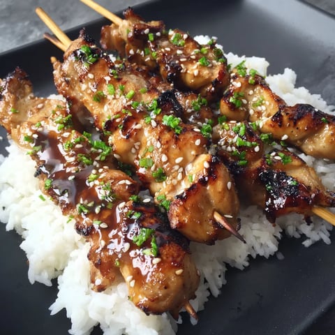 A plate of teriyaki chicken skewers.