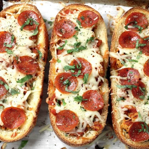A plate with three slices of cheesy pizza boats.