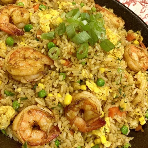 A delicious dish of fried rice with shrimp and veggies.