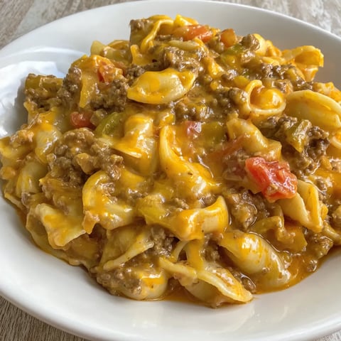 A serving of cheesy pasta with ground beef.
