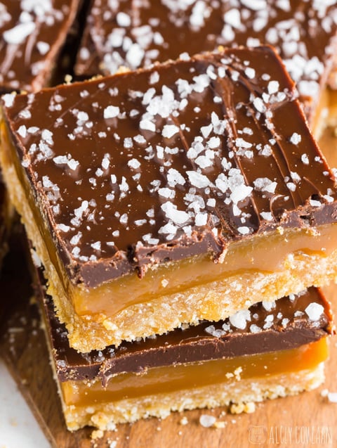 A close up of a piece of caramel millionaire bars.