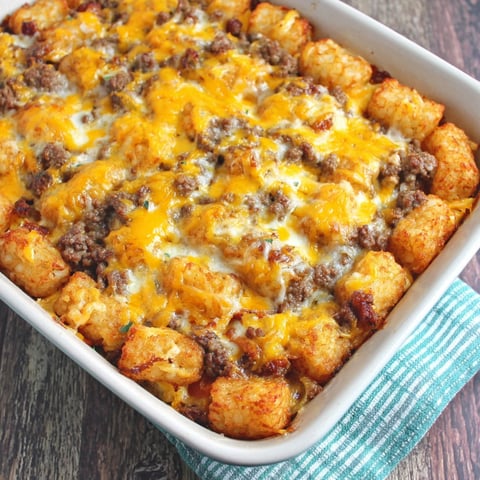 A dish of tater tots and sausage.