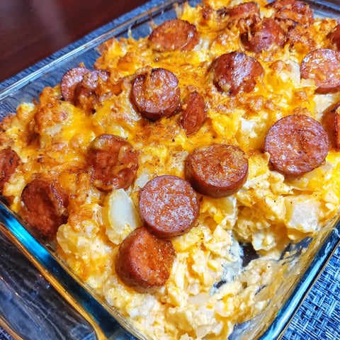 A hearty tray of cheesy potatoes and smoked sausage casserole.