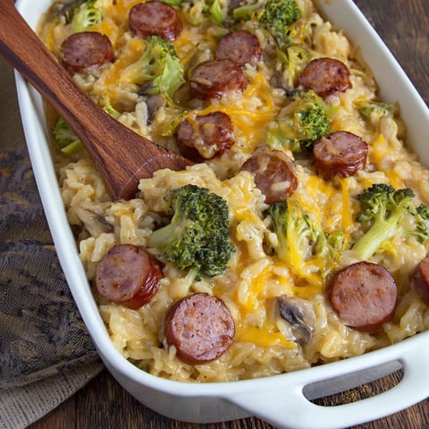 A cheesy casserole with sausage, broccoli, and rice.