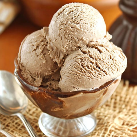 A glass bowl filled with ice cream.