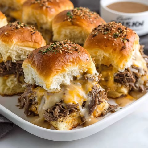 Golden beef sliders with gooey cheese on sweet Hawaiian rolls.