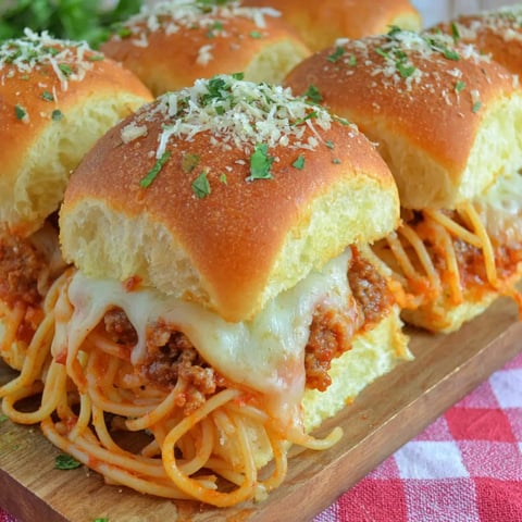 Plated cheesy spaghetti sliders with meat inside.