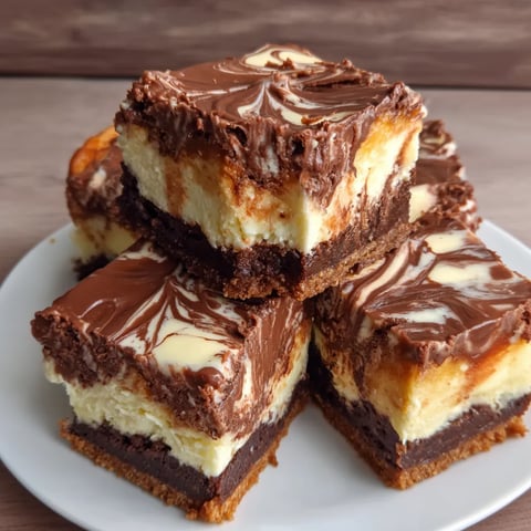 Nutella cheesecake bars stacked on a plate.