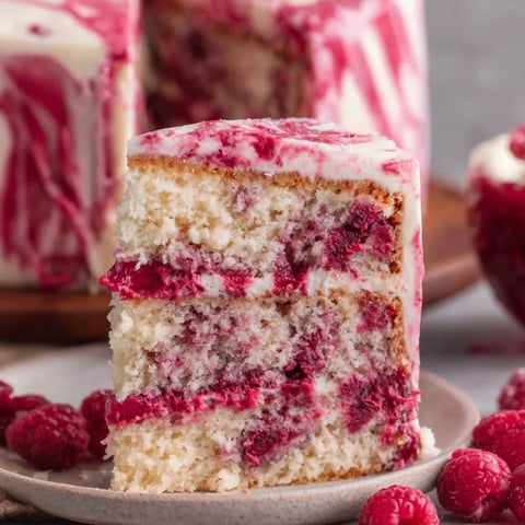 A slice of white chocolate raspberry cake.
