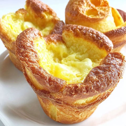 A plate with two muffins on it.