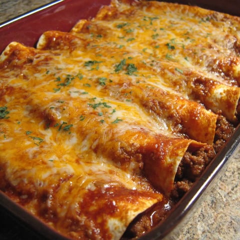 A dish of beef and bean enchiladas.