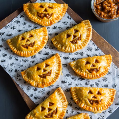 Spooky chorizo hand pies on a tray.