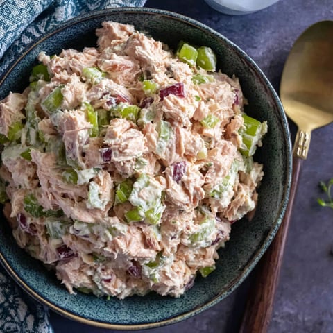 A bowl of tuna salad with a spoon.