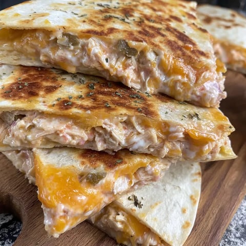 Stacked chicken quesadillas with melted cheese.