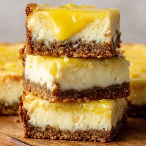 Three pieces of lemon cheesecake bars.