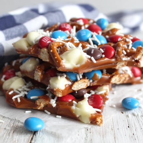 A stack of M&M bark with white and blue sprinkles.