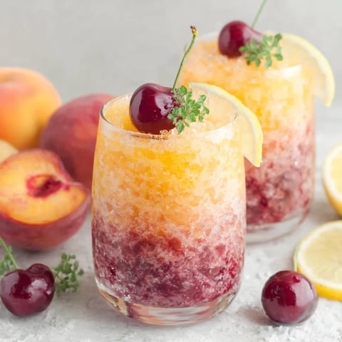 A glass of cherry peach slushie.