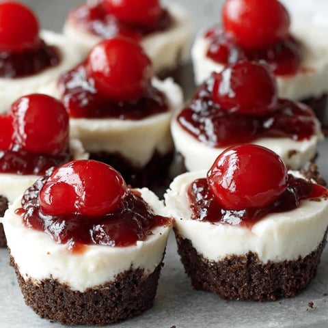 Mini cheesecakes with cherries on top.