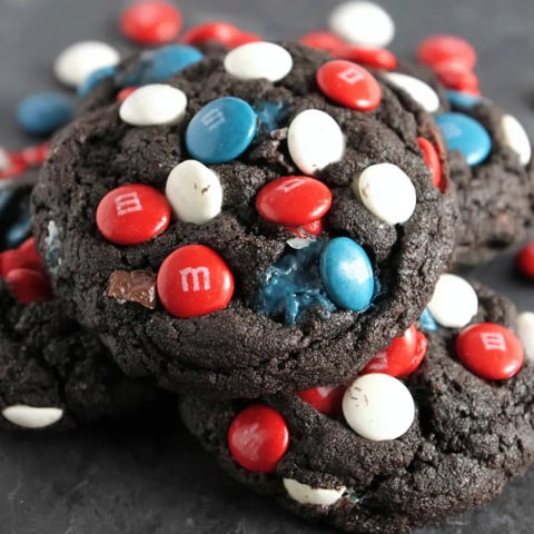 A chocolate cookie with white and red icing.