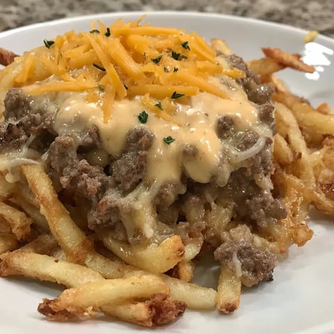 A cheeseburger french fry casserole on a plate.