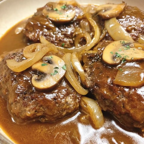 A plate of meat covered in gravy.