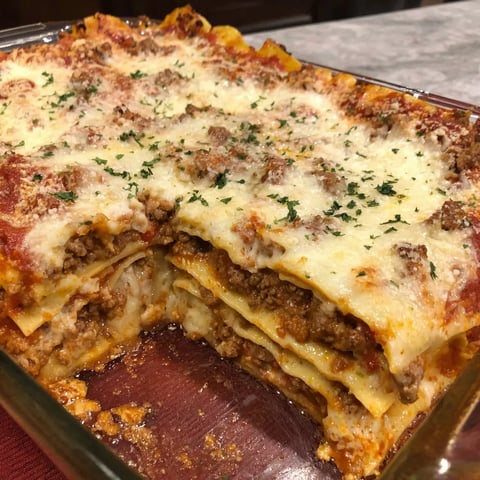A dish of lasagna with meat and cheese.