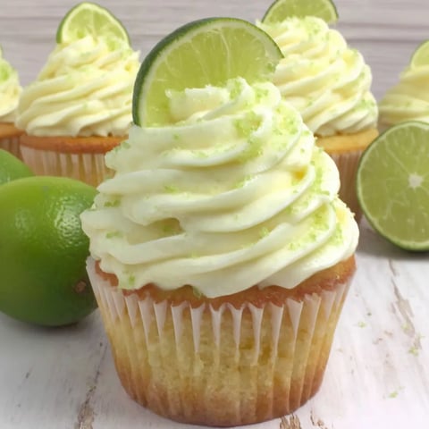 A cupcake with a green lime wedge on top.