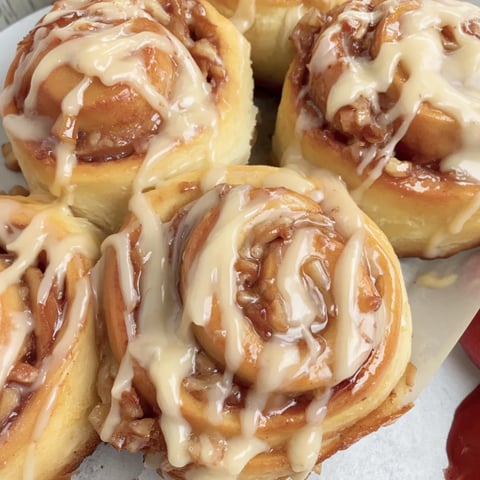 Three apple cinnamon rolls on a plate.