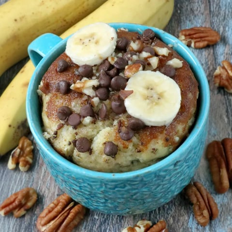 A blue mug filled with banana bread.