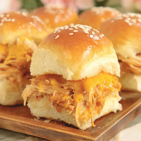 A plate of BBQ chicken sliders.
