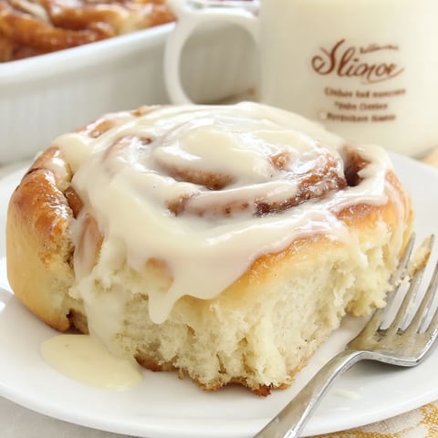 A cinnamon roll with cream cheese frosting.